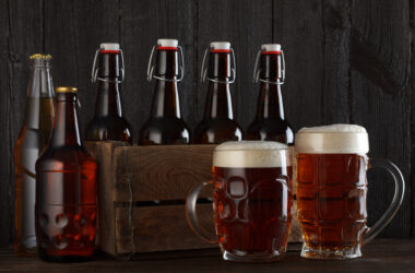 Beer glasses and bottles on table