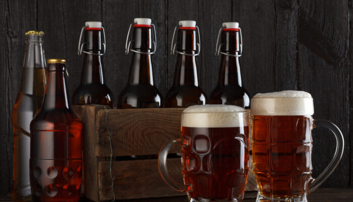 Beer glasses and bottles on table